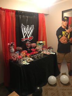 a man standing in front of a table with candy and candies on top of it