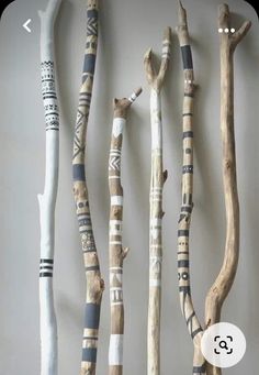 several different types of sticks are hanging on the wall