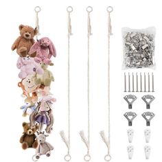 several stuffed animals are hanging from hooks and strings on a white background with other accessories