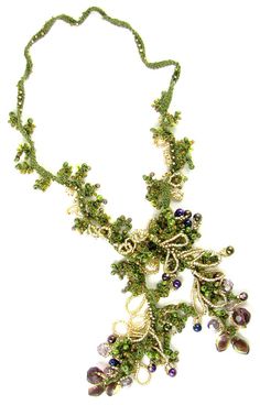 a necklace with beads and leaves on it