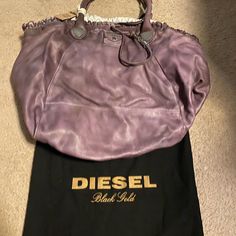 Nwt Diesel Black Gold Collection. Super Soft Leather, Very Large And Can Hold Lots Of Stuffs Designer Hobo Bag With Top Carry Handle, Luxury Purple Bags With Leather Handles, Designer Purple Tote Bag, Designer Purple Bags With Handles, Designer Purple Shoulder Bag With Handles, Designer Purple Double Handle Shoulder Bag, Purple Designer Shoulder Bag, Designer Satchel With Rolled Handles, Designer Purple Bags