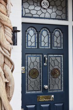 a blue front door with stained glass panels