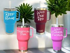 three different colored tumblers with the words wild, blue, and tropical pink on them