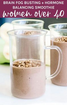 two mugs filled with chocolate and oatmeal on top of a table