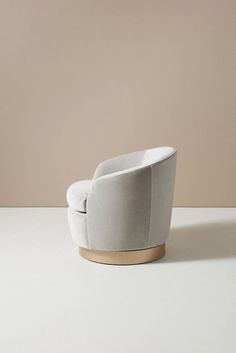 a white chair sitting on top of a table next to a brown and beige wall