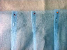 four pieces of blue fabric with red pins on them