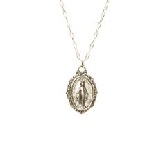 Virgin Mary medallion necklace, miraculous medal necklace, catholic, protection, a sterling silver mother of god on a sterling silver chain This sterling silver Virgin Mary hangs from a sterling silver chain in the length of your choice. This pendant is also available in 14k gold vermeil on a 14k gold filled chain. Charm measurements: 12mmx10mm. Looking for other charm necklaces? https://www.etsy.com/shop/BubuRuby?section_id=12318467 More crystals and healers? http://www.etsy.com/shop/BubuRuby?s Spiritual Sterling Silver Necklace With Miraculous Medal, Silver Spiritual Medallion Necklace Gift, Sterling Silver Charm Necklaces With Coin Pendant, Sterling Silver Charm Necklace With Coin Pendant, Sterling Silver Charm Necklace With Oval Coin Pendant, Silver Sterling Oval Charm Necklaces, Dainty Silver Locket Necklace With Round Pendant, Silver Dainty Locket Necklace With Round Pendant, Silver Oval Sterling Silver Charm Necklace