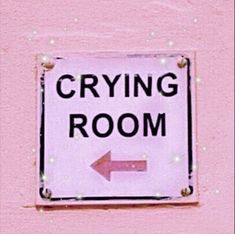 a sign that says crying room with an arrow pointing to the right on a pink wall