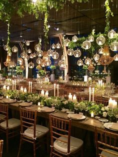 a long table is set up with candles and greenery for an elegant wedding reception