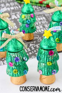 three green christmas trees made out of candy wrappers