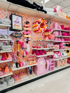 there are many items on the shelves in this store that is pink and orange with black accents