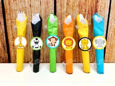 several different colored toothbrushes with animals on them