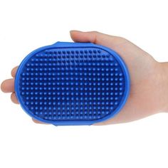 a hand holding a blue round object in it's left hand on a white background