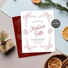 a card with the words christmas raffle on it next to sliced oranges and cinnamon sticks