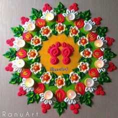 an intricately decorated wall hanging with candles in the shape of ganeshi on it