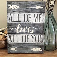 a wooden sign that says all of me loves all of you with arrows on it