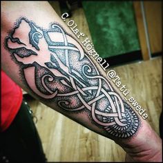 a man's arm with an intricate tattoo design on the forearm and hand,