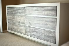 a white dresser sitting on top of a carpeted floor