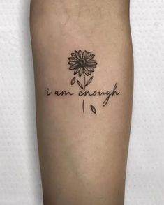 a tattoo with the words i am enough and a flower on it's leg