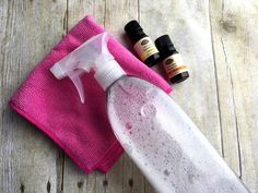 an ironing board, cloth and bottles of essential oils on a wooden table top