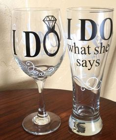 two wine glasses that say i do and what she says on them are sitting on a table