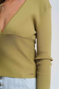 V-neck ribbed sweater in green. This summer-weight fine-knit beige sweater has a deep v-neck, long sleeves, and a bodycon fit. Pair it with a pair of boyfriend jeans, as shown. Or wear with shorts, a skirt, white jeans, or leggings. The lightweight knit fabric feels silky and soft because it is made out of 65% Viscose and 35% Polyamide. Viscose provides a silky feel that is breathable. Polyamide affords a softer feel with added flexibility. Polyamide was initially designed as a substitute for si Chic Green V-neck Sweater, Fitted Ribbed V-neck Sweater, Ribbed Stretch V-neck Sweater, Trendy Ribbed Stretch V-neck Sweater, Trendy Stretch Ribbed V-neck Sweater, Trendy Fitted Ribbed V-neck Sweater, Trendy Fitted V-neck Sweater, Tan Scarf, Fine Knit Sweater