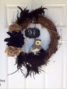 a wreath with an owl sitting on top of it