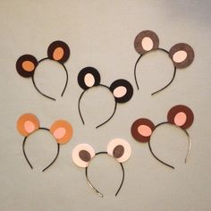 mickey mouse ears made out of paper on a white surface with pink, brown and black circles