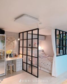 a room with a bed, desk and mirror on the wall next to an open door