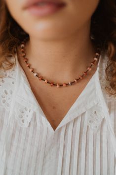 A necklace perfect for the upcoming holidays! Gunmetal chain detailing Pinkish-red tones in the beading 16 and 18 chain options with 2 inch extender Please measure neck before ordering. Orange Beaded Choker Jewelry, Beaded Chain Crystal Choker Necklace, Long Single Strand Beaded Necklace, Red Choker Necklace With Colorful Beads, Adjustable Colorful Beads Chain Necklace, Adjustable Single Strand Coral Beaded Necklace, Adjustable Coral Beaded Single Strand Necklace, Adjustable Coral Single Strand Beaded Necklace, Elegant Adjustable Coral Necklace