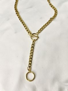 "Necklace comes in gold plated stainless steel or silver stainless steel. Necklace length around neck comes in 14.5\" - 17\" and drop is 4\". This solid and unique necklace is great alone or worn as a layering piece. Wear it as a necklace or as a lariat as shown in the photos! This necklace is a necklace that will dress up your outfit while giving you an edge. Great piece to add to your collection. Such a comfortable and amazing quality piece that you will reach for over and over! It is of great Gold-tone Toggle Necklace With Gold Chain As Gift, Gold-tone Toggle Chain Necklace For Gifts, Gold Lariat Necklace With Toggle Clasp, Gold-tone Toggle Chain Necklace Gift, Everyday Gold Lariat Necklace With Lobster Clasp, Gold-tone Toggle Necklace Gift, Minimalist Metal Toggle Necklace With Adjustable Chain, Metal Lariat Necklace With Chain Detail, Gold Metal Lariat Necklace With Lobster Clasp