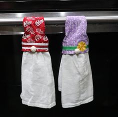 two hand towels are hanging on a towel rack