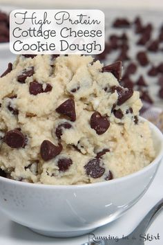 a close up of a bowl of cookie dough with chocolate chips on top and the words high protein cottage cheese cookie dough above it