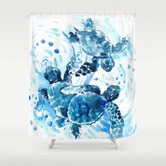 a blue and white shower curtain with two turtles swimming in the water on top of each other