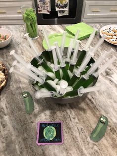 a kitchen counter topped with lots of green items