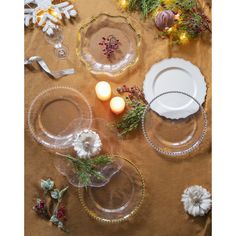 the table is set with plates, candles and other holiday decorations on top of it