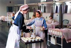 two women in aprons are serving food to each other