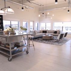 a living room filled with furniture and lots of windows