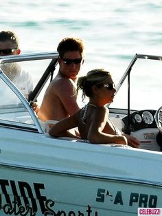 a group of people riding on the back of a white boat