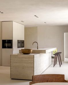 a modern kitchen with an island counter and sink