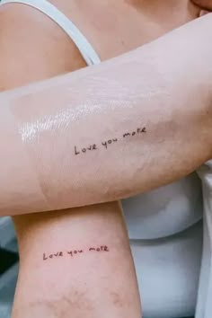 two women with tattoos on their arms that say love you more and the words love you more are written in cursive font