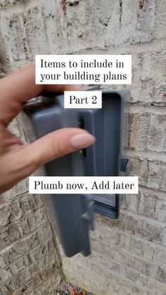 a hand is pointing at a building plan on the side of a brick wall with text that reads items to include in your building plans part 2 plum now, add later