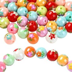 many different colored plastic beads on a white background