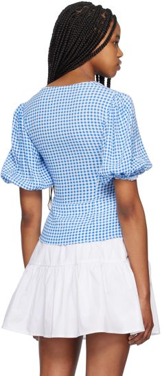 European Union Ecolabel-certified stretch LENZING™ ECOVERO™ viscose crepe blouse. Gingham pattern throughout. · Square neck · Button closure · Elasticized cuffs Supplier color: Strong blue Spring Gingham V-neck Top, Gingham V-neck Tops For Spring, Fitted Gingham V-neck Top, Gingham V-neck Blouse For Summer, Spring Gingham V-neck Blouse, Fitted Gingham Blouse With Puff Sleeves, Summer Gingham Blouse For Workwear, Gingham Short Sleeve Blouse For Work, Summer Gingham Blouse For Work