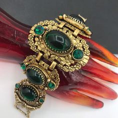 995.60 USD 1960's Green Rhinestone Bracelet, Victorian Revival Bracelet, Chunky High End Jewelry 1950s Collectible Accessories, Vintage Gift For Her Just love this bracelet that is in excellent well cared for vintage condition. Has a really nice look to it. Very nice addition to any collectible mid-century collection. For more purses.... https://www.etsy.com/shop/MartiniMermaid?ref=listing-shop2-all-items-count§ion_id=8097288 For more bracelets ......… Luxury Vintage Leather Bracelet, 80s Vintage Jewelry, Luxury Retro Bracelet Jewelry, 1970 Vintage Cast Iron Minnie Mouse Green Clothing Necklace, Luxury Vintage Jeweled Bracelets, Luxury Vintage Cuff Bracelet Gift, Affordable Vintage Stretch Bracelet, Luxury Vintage Round Bracelets, Victorian Jeweled Wedding Bracelets