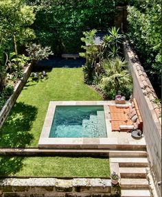 an aerial view of a small backyard with a pool