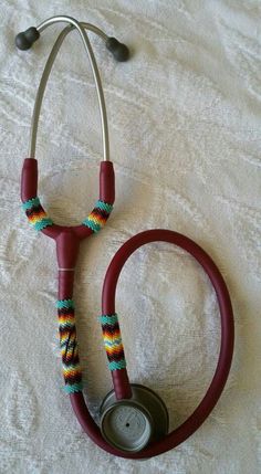 a red stethoscope laying on top of a bed