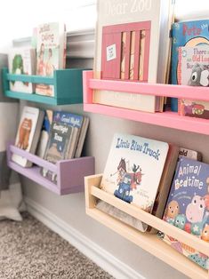 books are lined up on shelves in the children's room