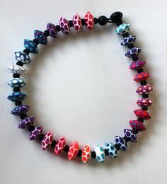 a bracelet with multicolored hearts and black beads