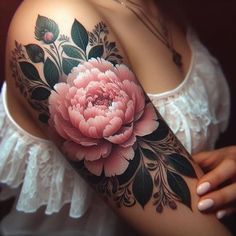 a woman's arm with a pink flower on it and leaves around the arm